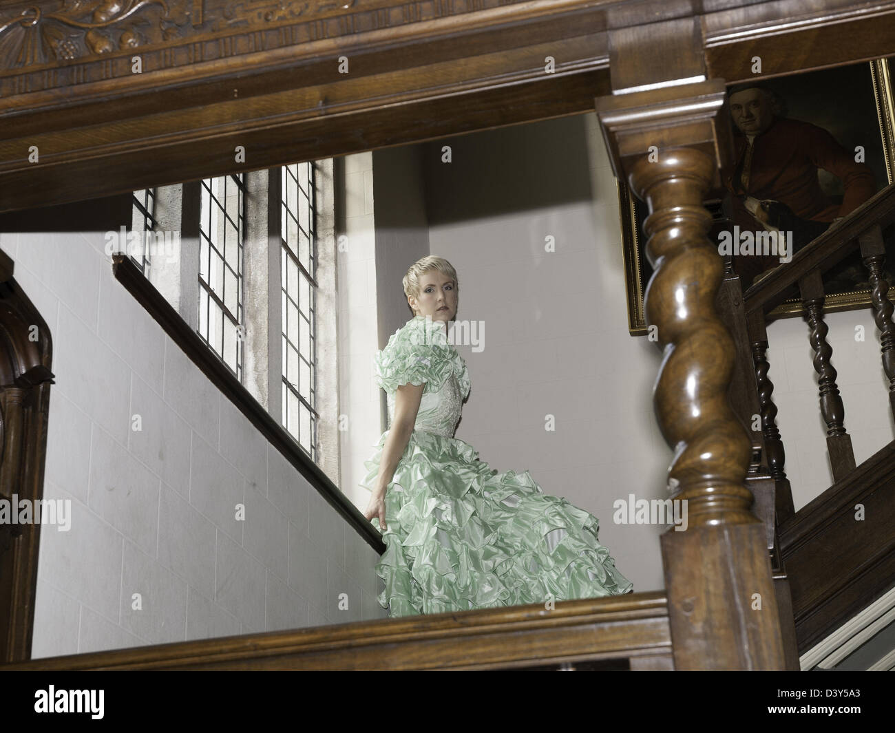 Girl on stairs ready for the party wearing a ball gown Stock Photo