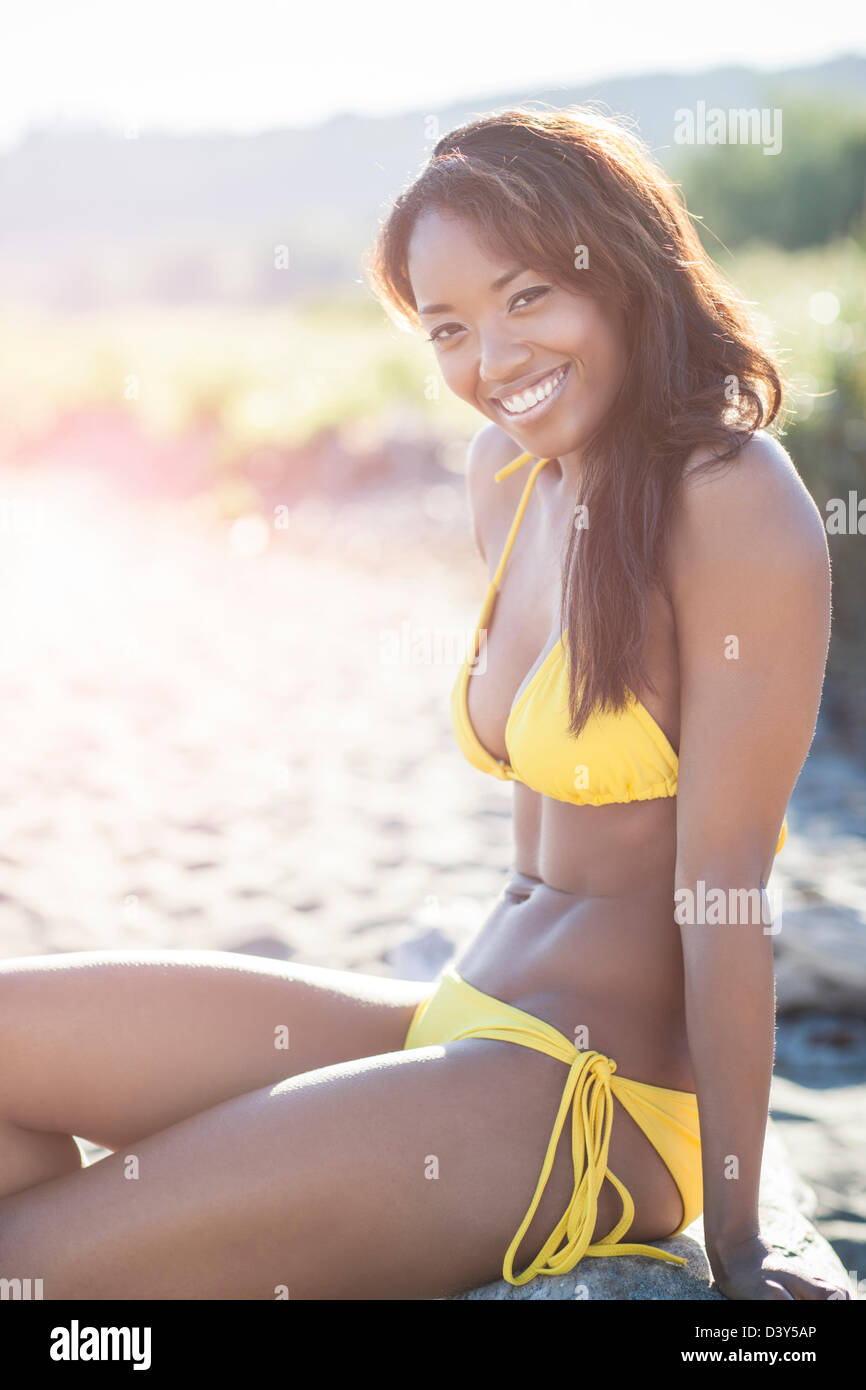 Mixed race woman in bikini on beach Stock Photo - Alamy
