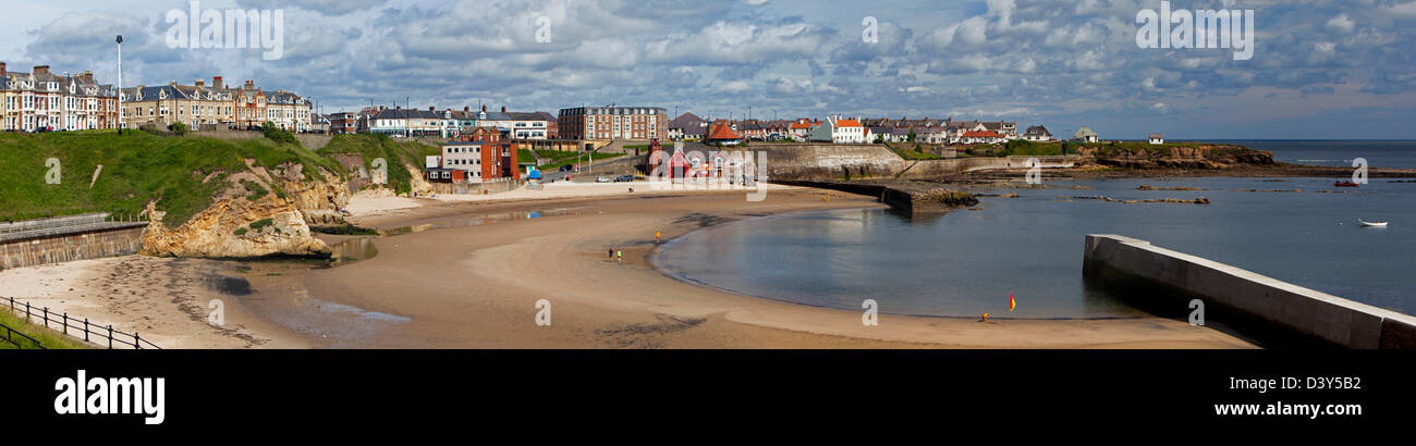 A daytime summer panoramic view of Cullercoats harbour and village viewed from the South Stock Photo