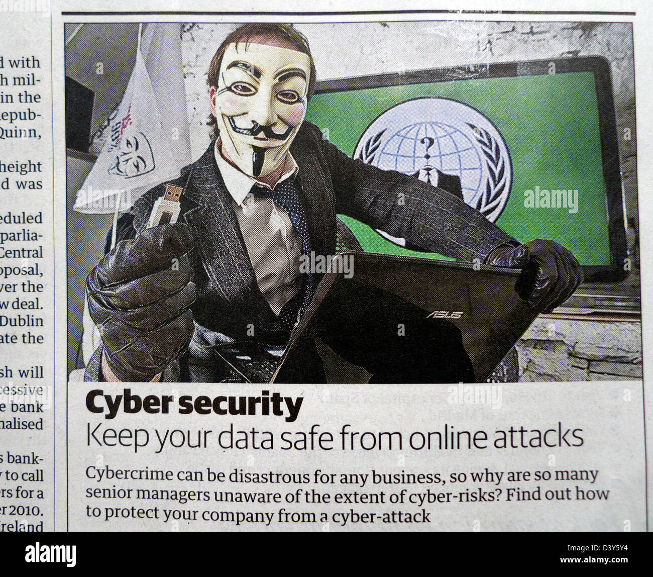 Cyber security newspaper advertisement with Anonymous hacker and memory stick UK Stock Photo