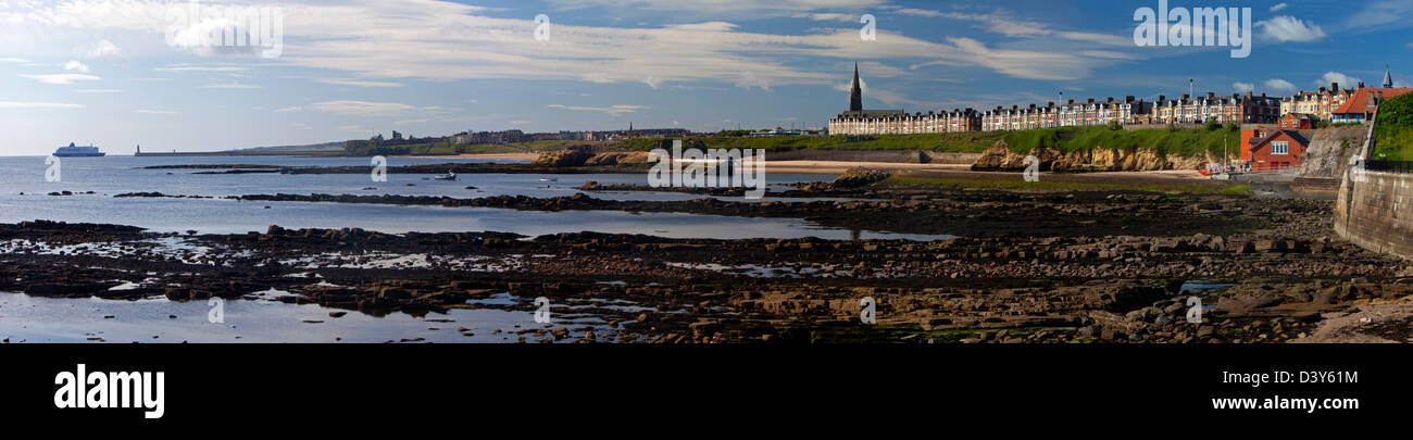 A panoramic view in early morning in late summer of Cullercoats Bay in North Tyneside looking towards Tynemouth Stock Photo
