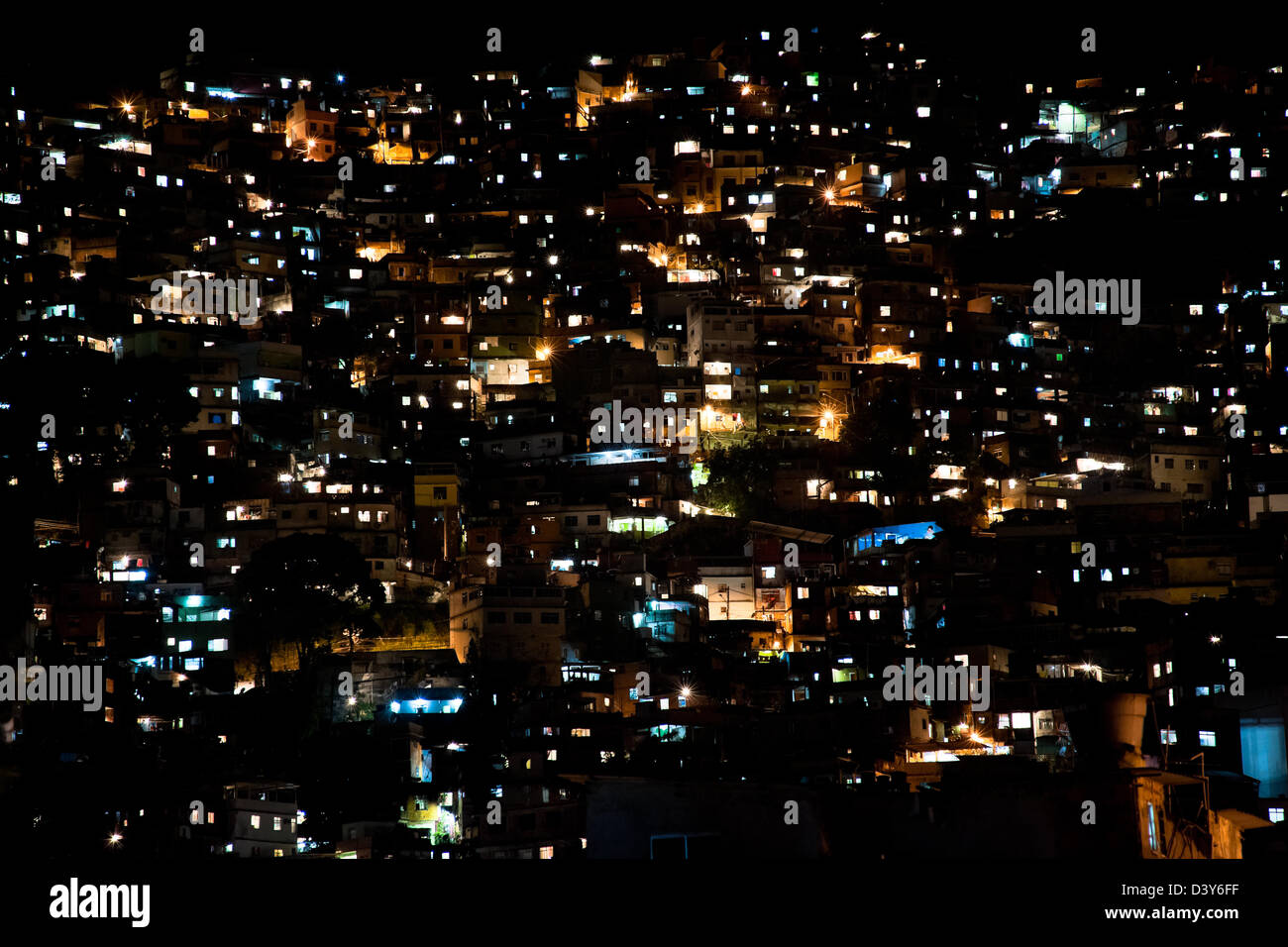 City lights seen on a steep hillside in the favela of Rocinha, Rio de ...