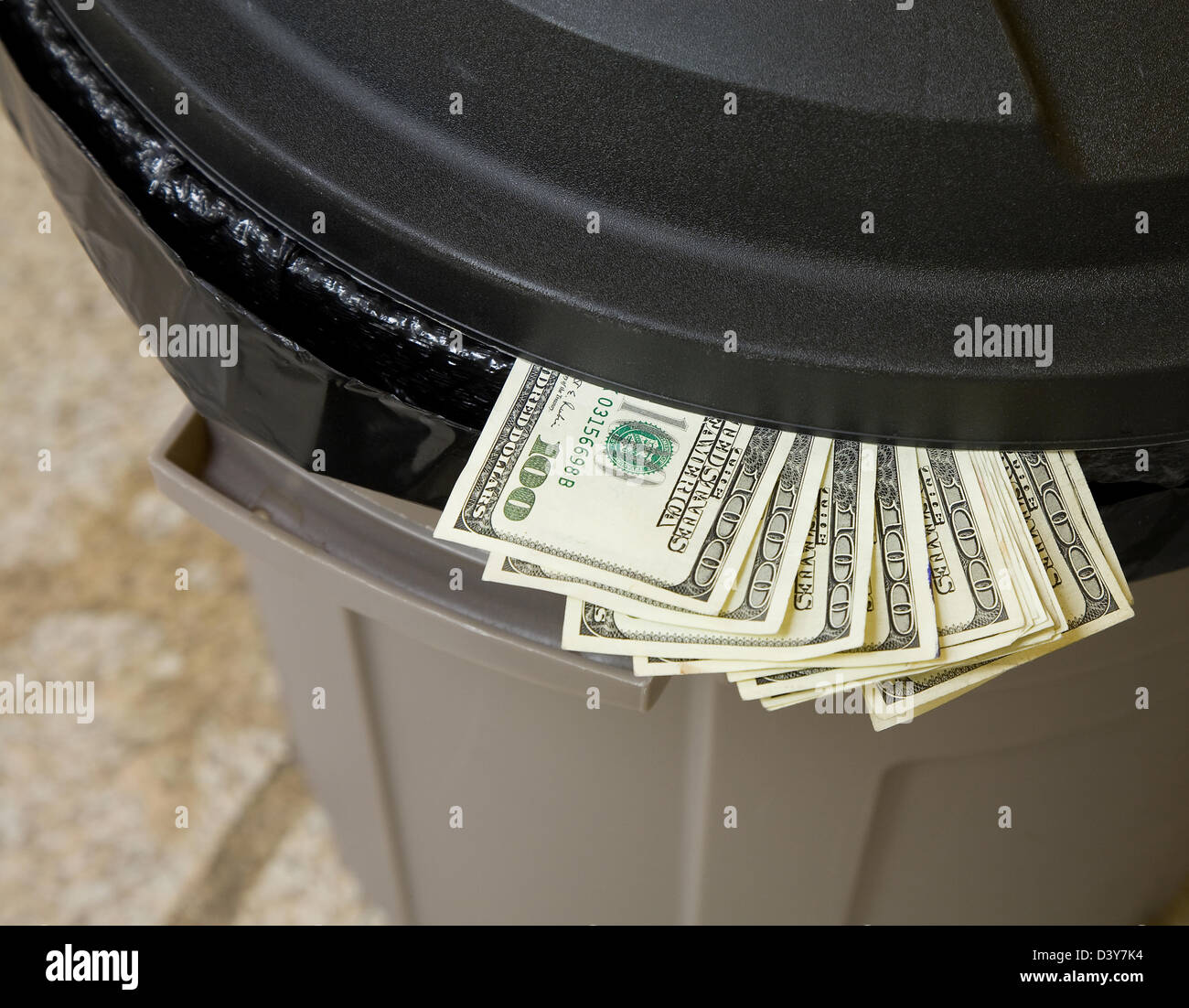 A bundle of 100 dollar bills in a trash can Stock Photo Alamy