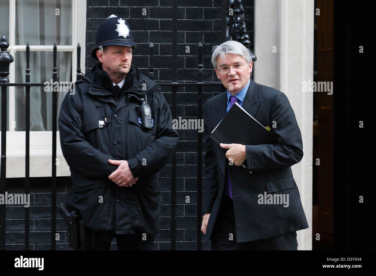 Conservative MP Andrew Mitchell passes a police officer as he leaves Number 10 Downing street in London on 23 March 2011. Stock Photo