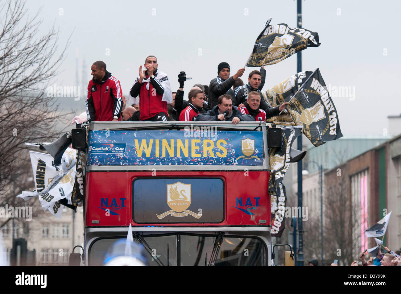 Swansea, Wales, UK. 26th February 2013. Swansea City Football team and fans celebrating during an open-top bus parade through the centre of Swansea after beating Bradford City 5-0 in Sunday's Capital One Cup final at Wembley to win the Capital Cup trophy. Credit:  Phil Rees / Alamy Live News Stock Photo