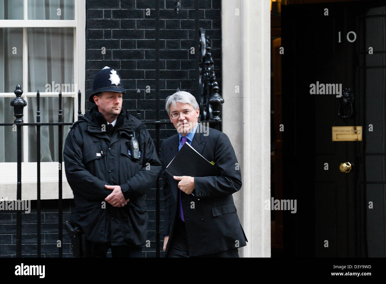 Conservative MP Andrew Mitchell passes a police officer as he leaves Number 10 Downing street in London on 23 March 2011. Stock Photo
