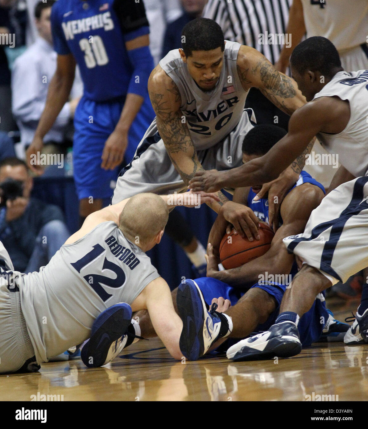 Cincinnati, Ohio, USA. 26th February 2013. Xavier Musketeers players Xavier Musketeers guard Brad Redford (12),Xavier Musketeers forward Justin Martin (20) and Xavier Musketeers forward Travis Taylor (4) try there best to take a ball away from Memphis Tigers guard Geron Johnson (55). In the second half of play on Tuesday, February 26, 2013. During play at the Cintas Center in Cincinnati,Ohio. (Credit Image: Credit:  Ernest Coleman/ZUMAPRESS. com/Alamy Live News) Stock Photo