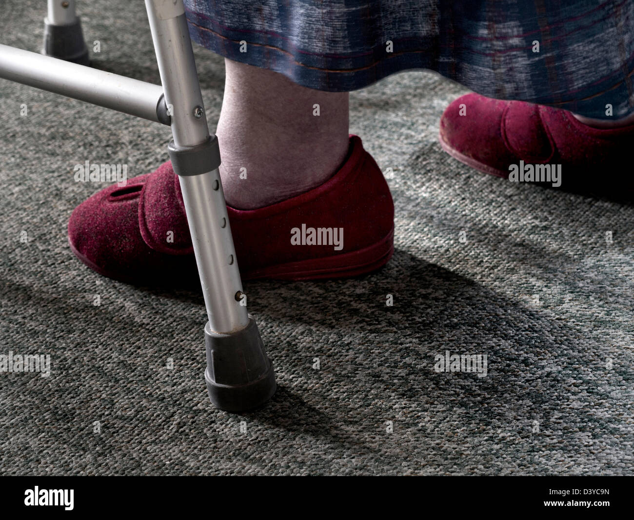 Close view on elderly lady using a Zimmer frame for safety balance and stability at home during  walking Stock Photo