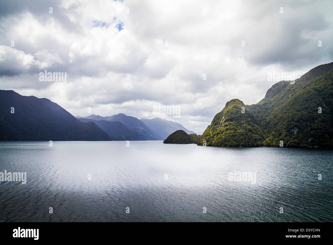 Sun streaming through clouds on spectular Milford Sound, South Island, New Zealand Stock Photo