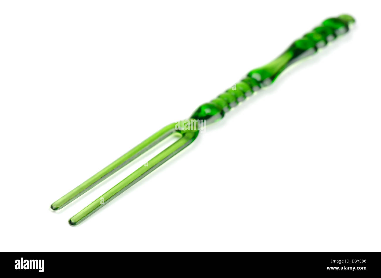 Green disposable plastic cocktail fork isolated on white Stock Photo