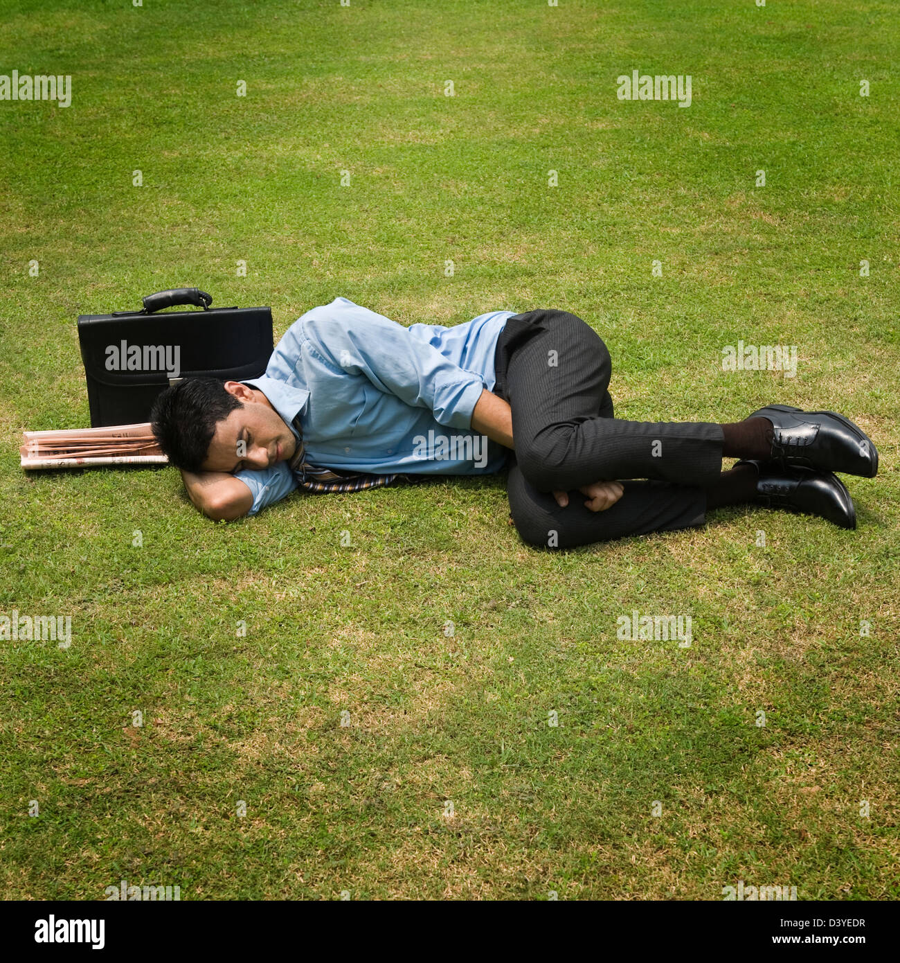 Businessman sleeping in a park Stock Photo Alamy