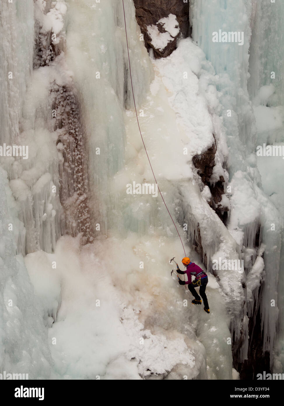 Alpinist ascenting a frozen waterfall in Ice park, Ouray Stock Photo ...