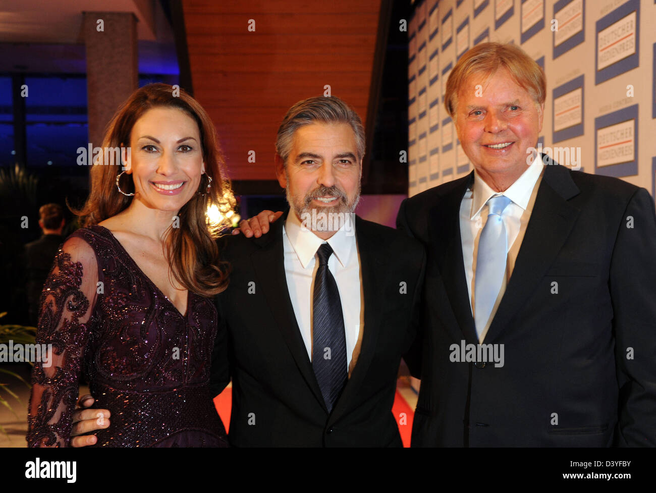 Baden-Baden, Germany. 26th February 2013. The prizer winner of the German Media Prize 2012, US actor George Clooney (R), arrives for the award ceremony with Karlheinz Koegel of Media Control and Koegel's wife Dagmar in Baden-Baden, Germany, 26 February 2013. Photo: Uli Deck/dpa/Alamy Live News Stock Photo