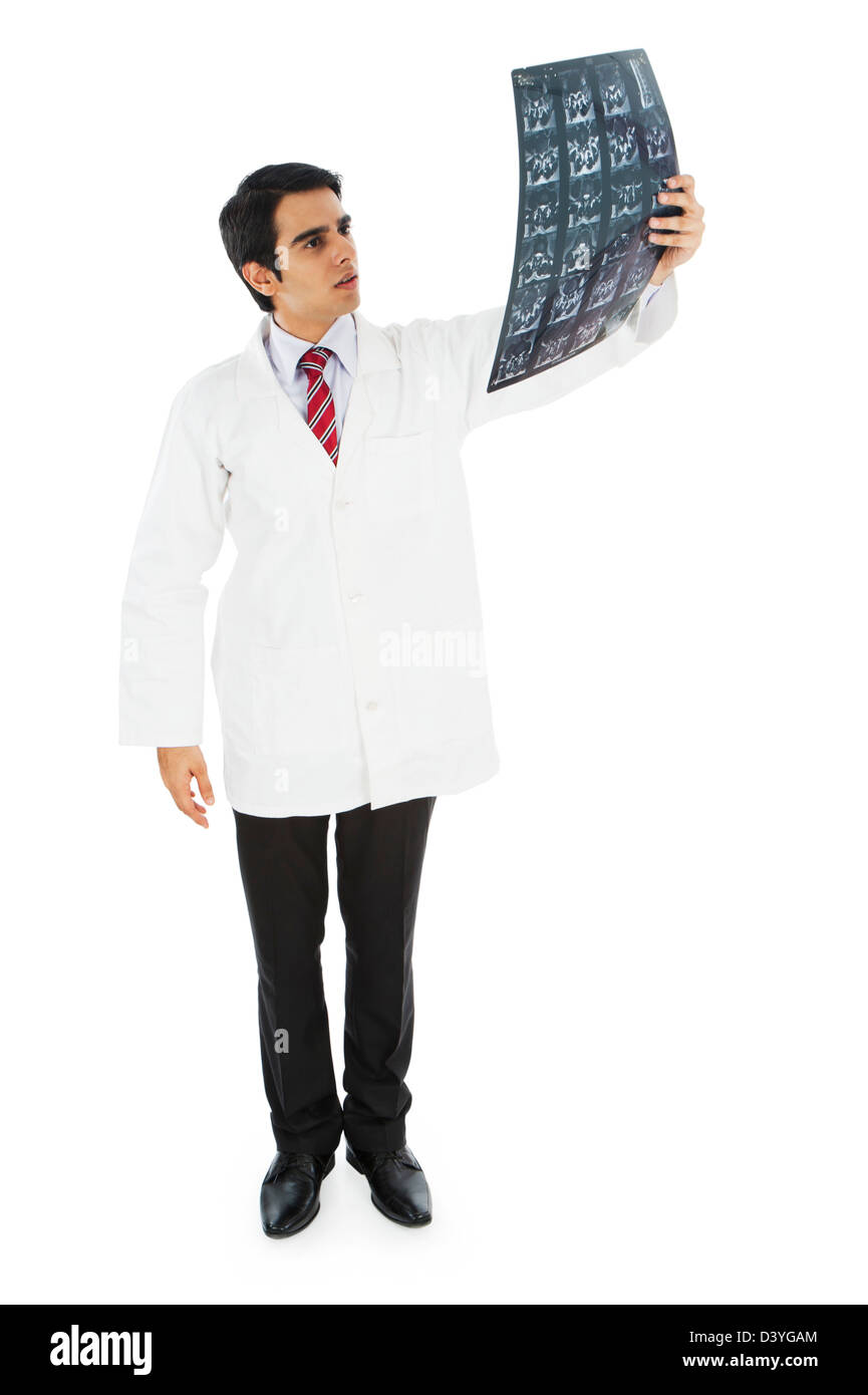 Male doctor examining an MRI report Stock Photo