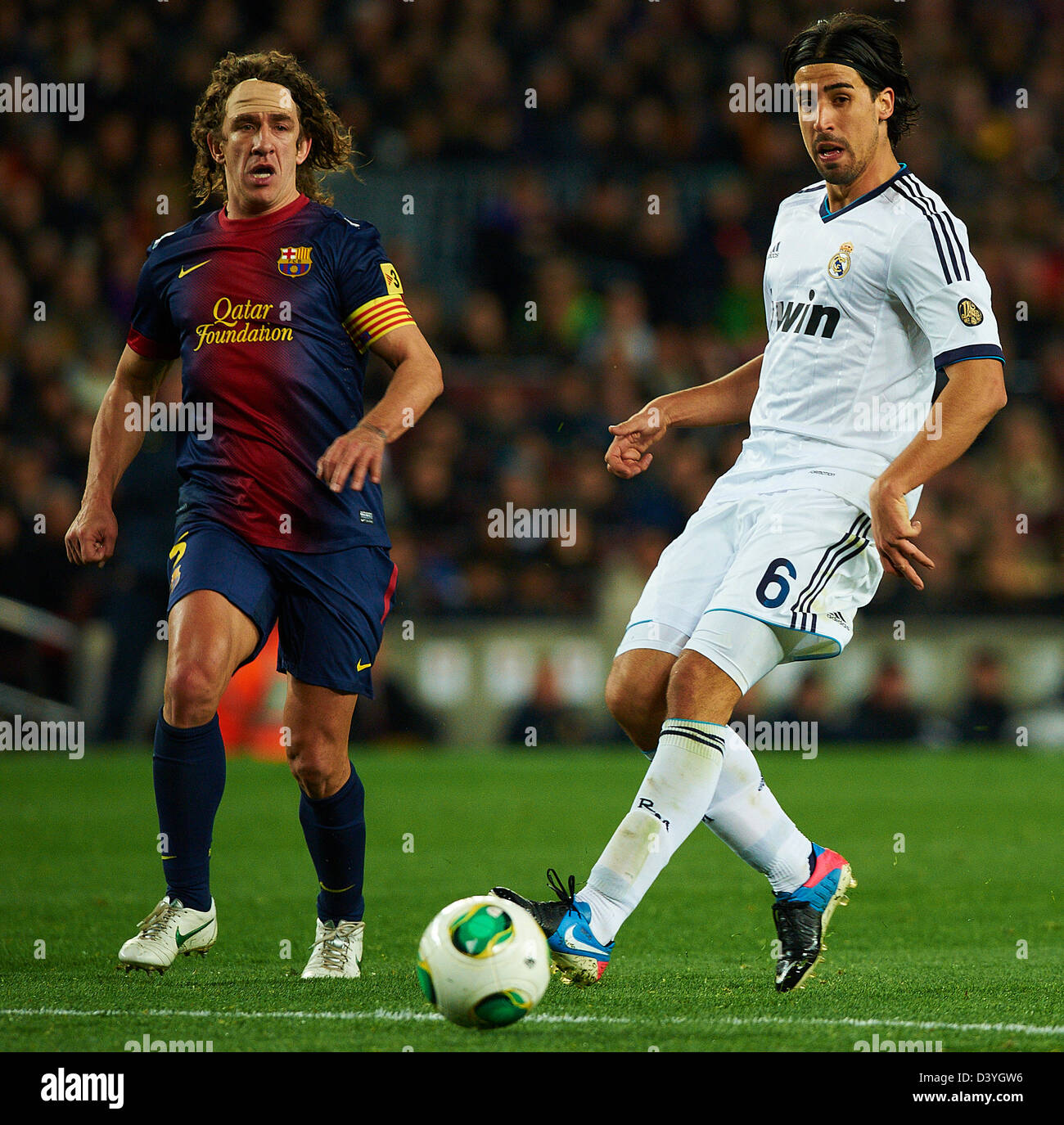 Barcelona, Spain. 26th February 2013. Carles Puyol (FC Barcelona) duels for the ball against Sami Khedira (Real Madrid CF), during Kings Cup soccer match between FC Barcelona and Real Madrid CF, at the Camp Nou stadium in Barcelona, Spain, tuesday, February 26, 2013. Foto: S.Lau/dpa/Alamy Live News Stock Photo