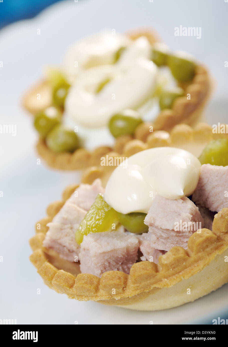 tartlet with salad on a white plate .Shallow depth-of-field Stock Photo