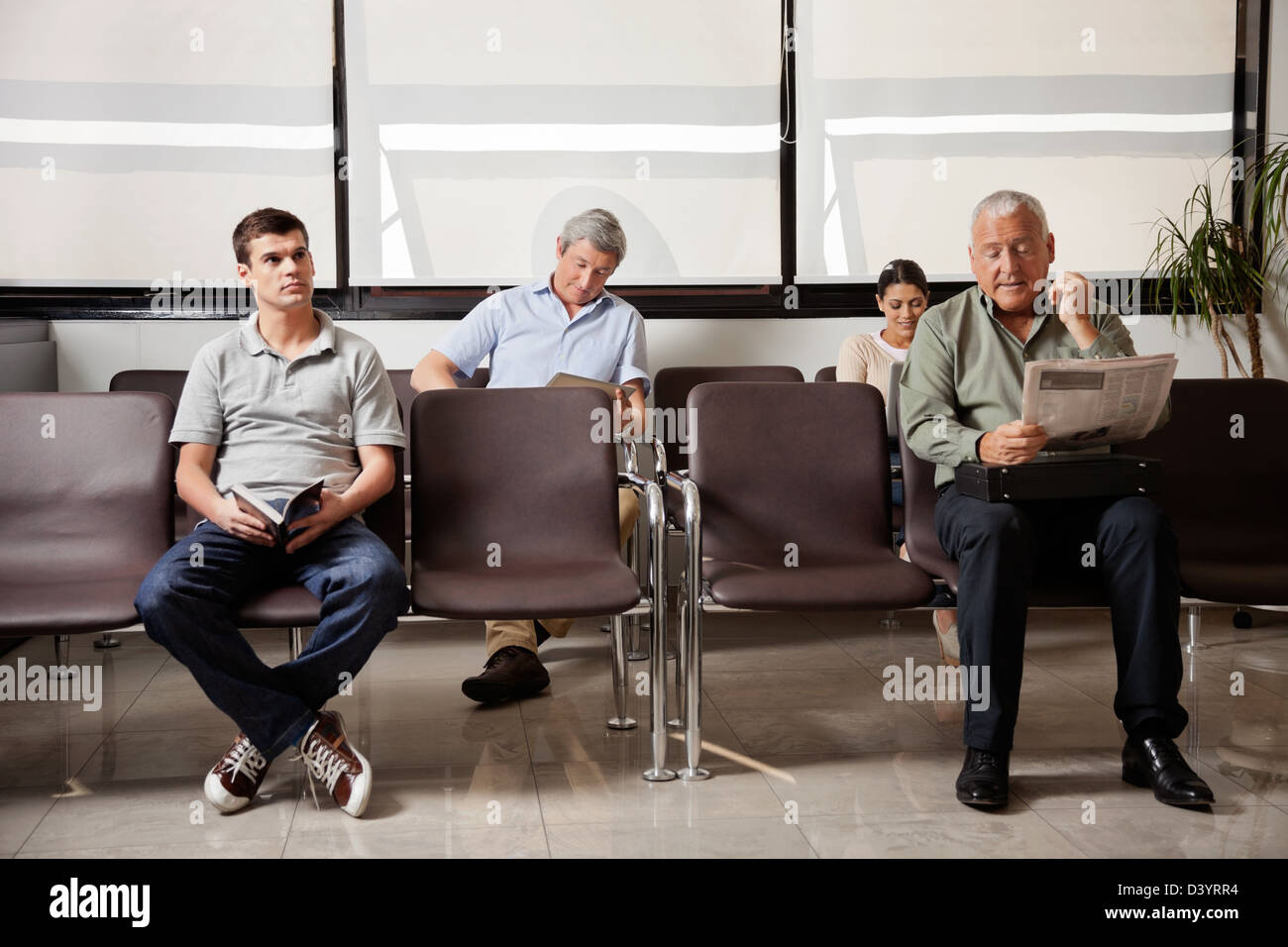 People Waiting In Hospital Lobby Stock Photo