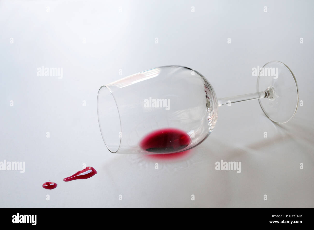 Knocked over glass and split wine. Stock Photo