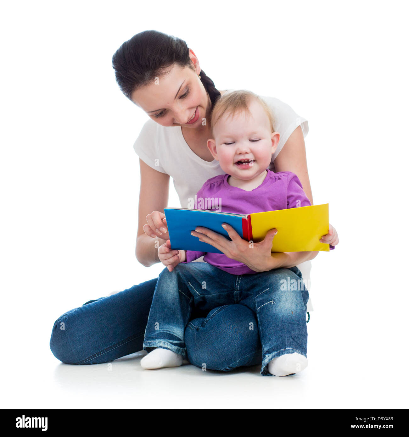 happy mother reading a book to baby girl Stock Photo
