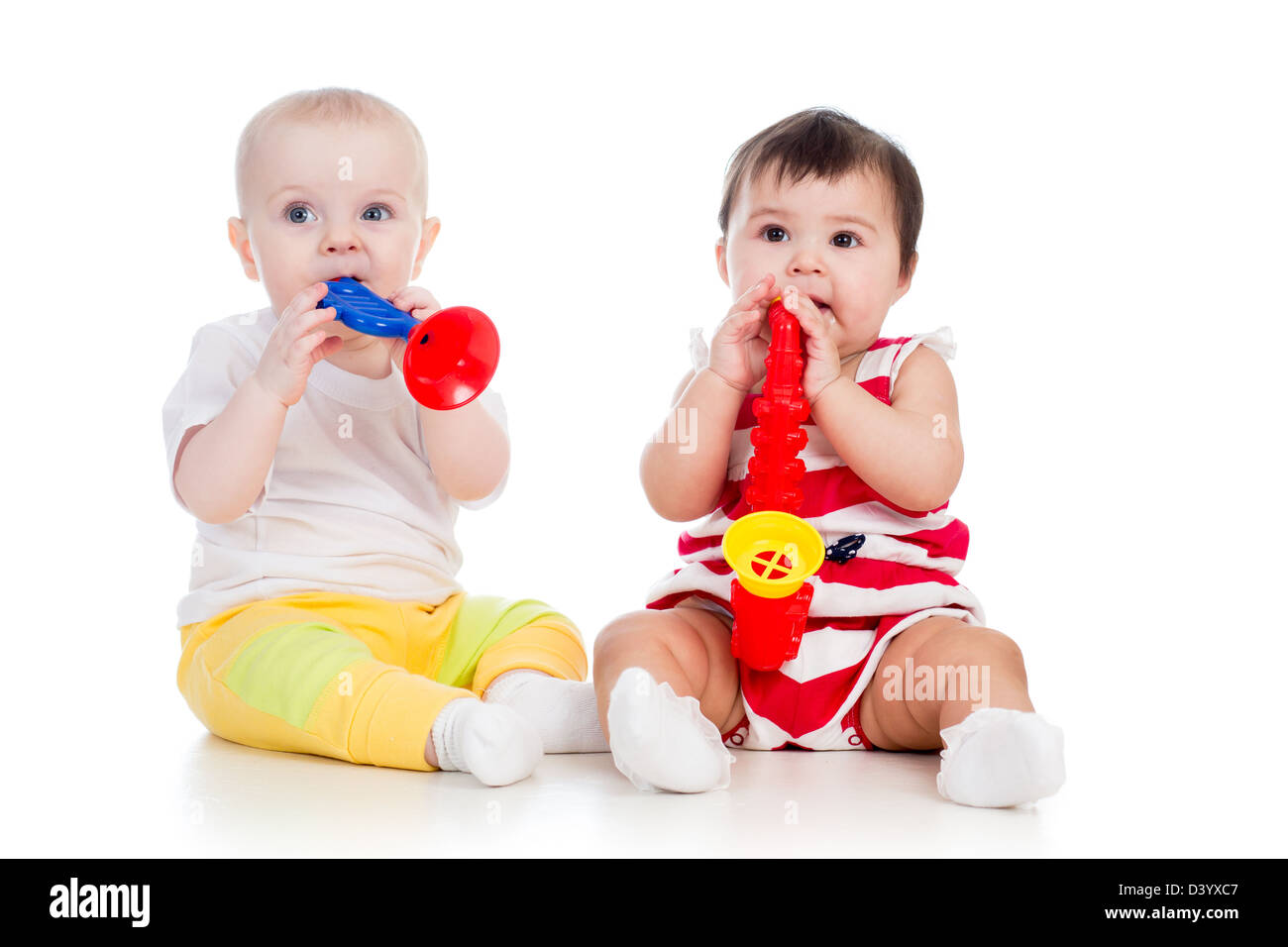 Funny babies girls with musical toys. Isolated on white background Stock Photo