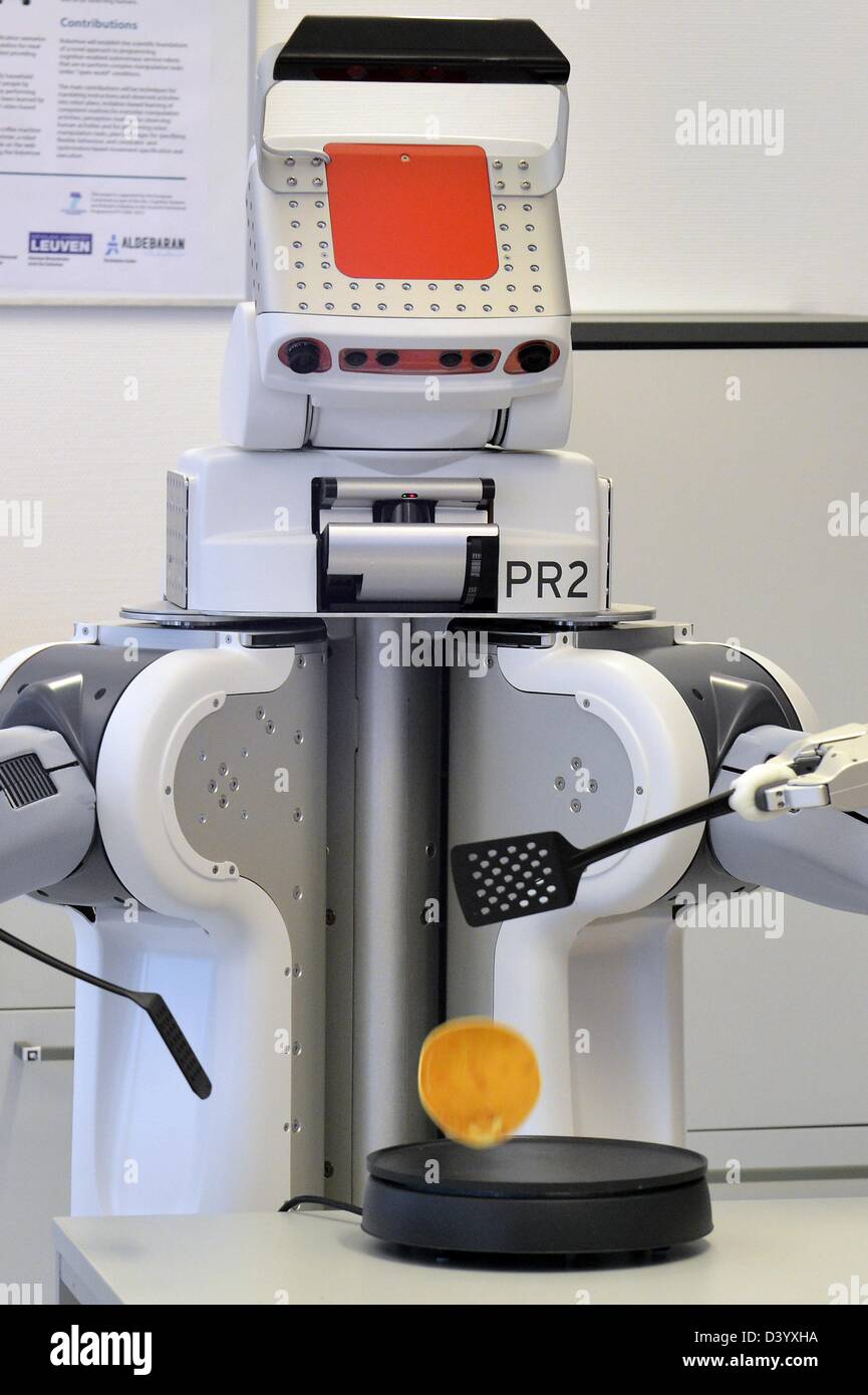 Bremen, Germany. 27th February 2013. Robot 'PR2' flips a pancake in a laboratory kitchen of the Institute for Artificial Intelligence (IAI) at the Institute of Informatics and Automation (TZI) of Bremen University. The robot can experimentally do household tasks and is part of a Europe wide project. Photo: MICHAEL BAHLO/dpa/Alamy Live News Stock Photo