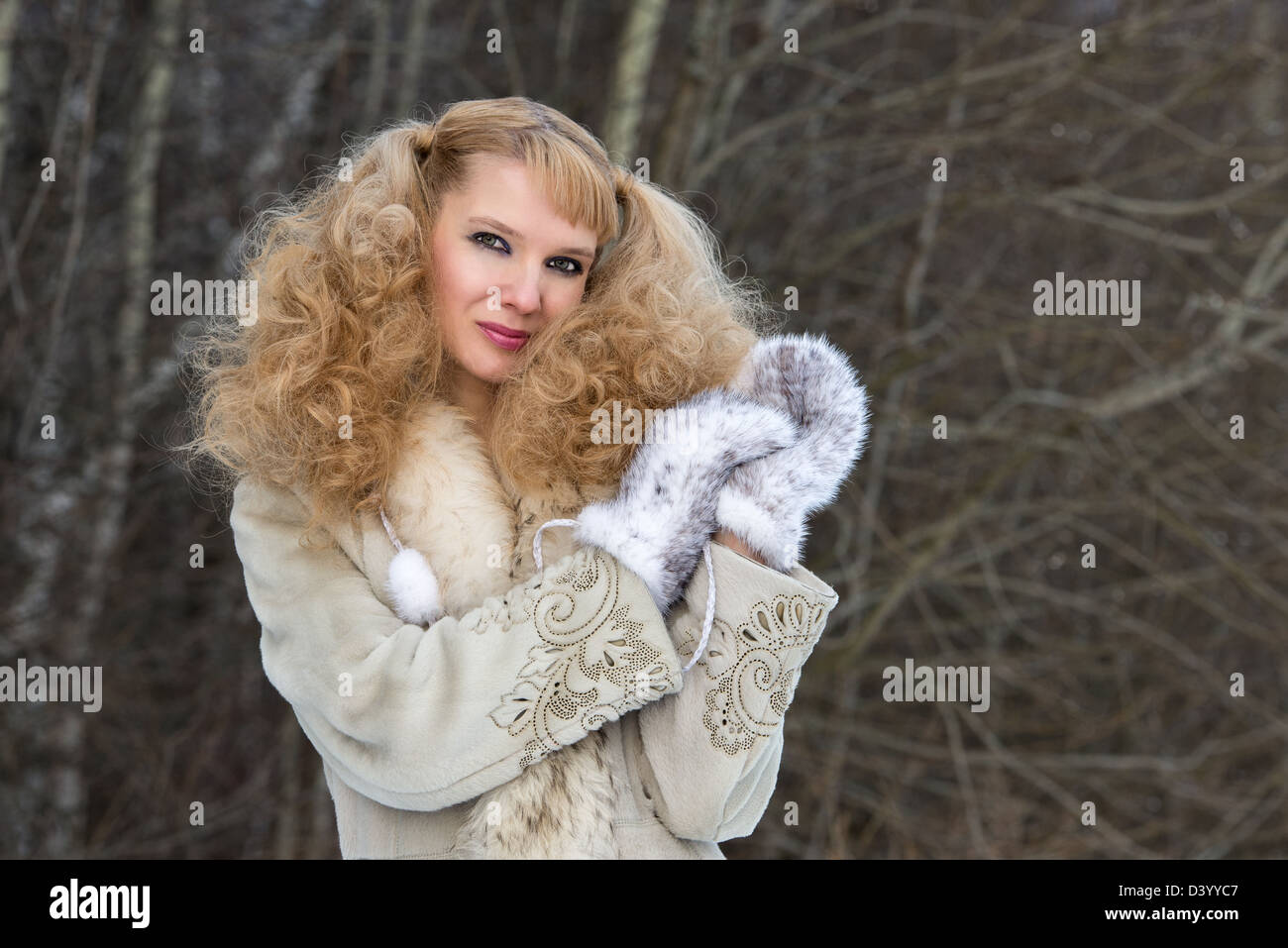Smiling pretty young woman in a winter forest in a fur coat Stock Photo ...