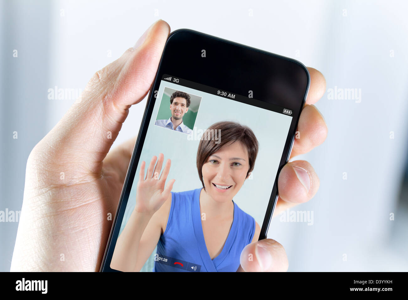 Closeup of a male hand holding a smartphone during a video call with his girl field Stock Photo