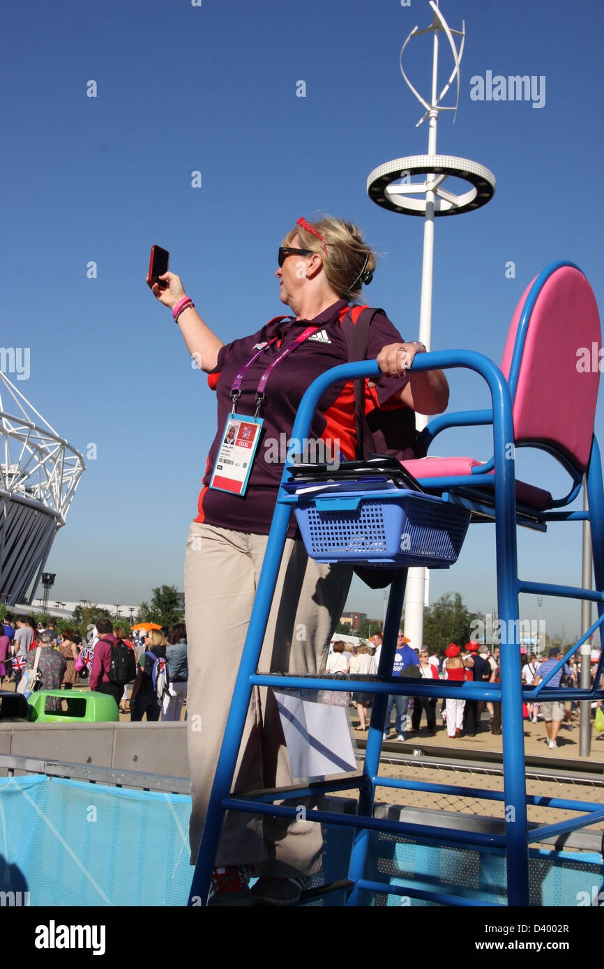 A games maker takes a photograph at the London 2012 Paralympic games. Stock Photo