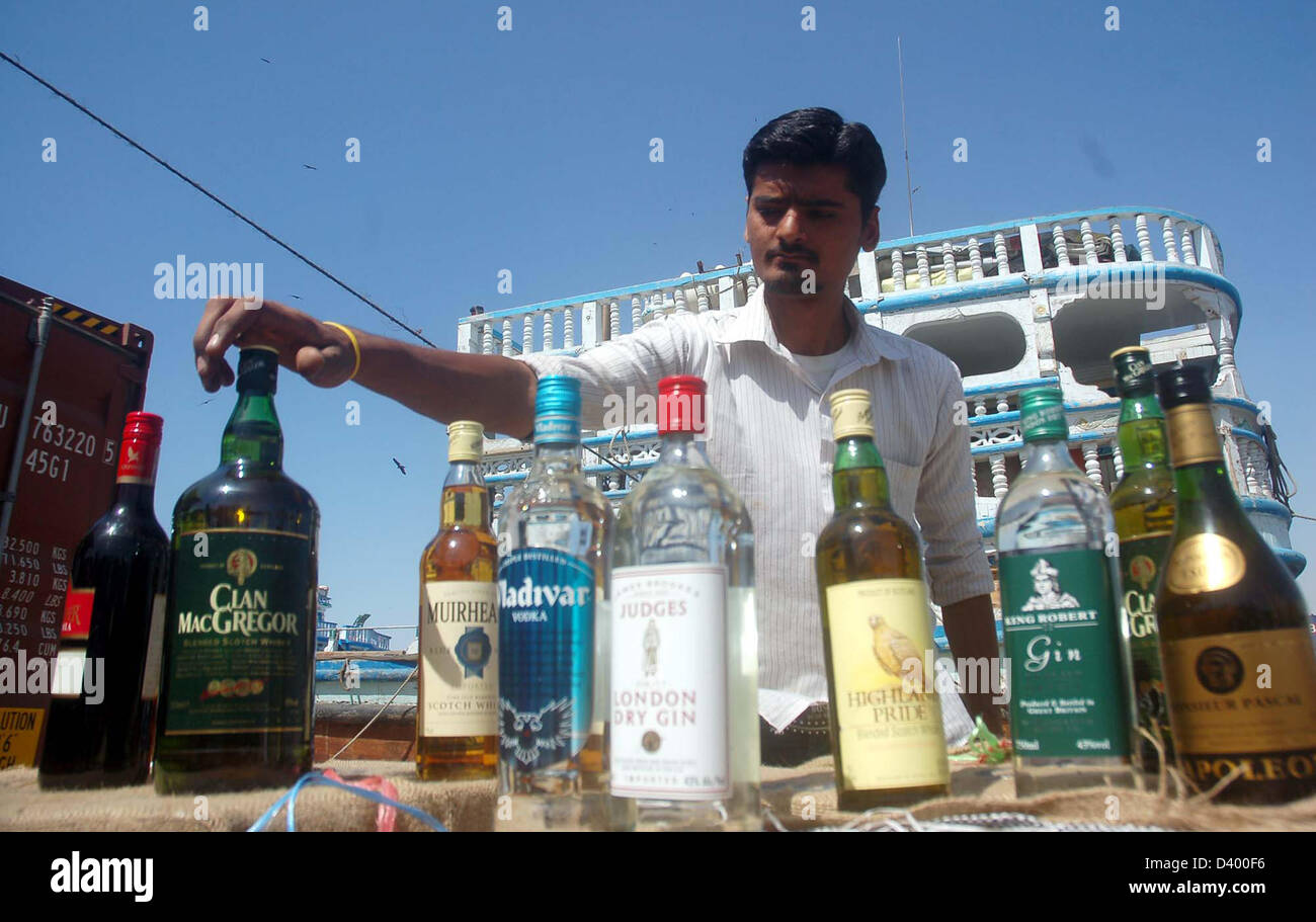Customs officials show seized illegal imported liquors bottles that