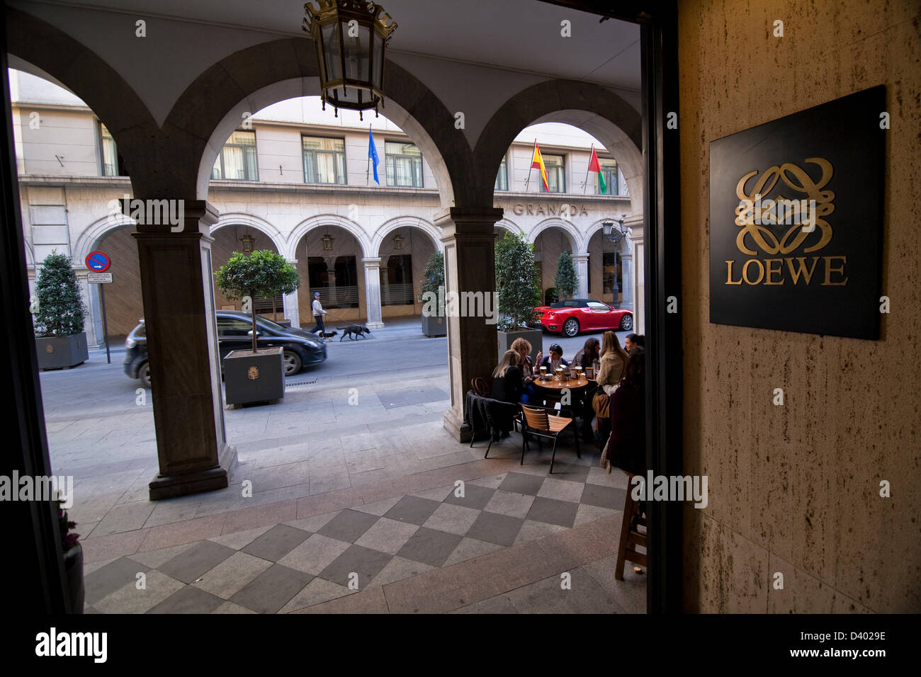 Logotype of a luxury shop and Ferrary car in arcades in street of Angel Ganivet. Granada. Spain Stock Photo