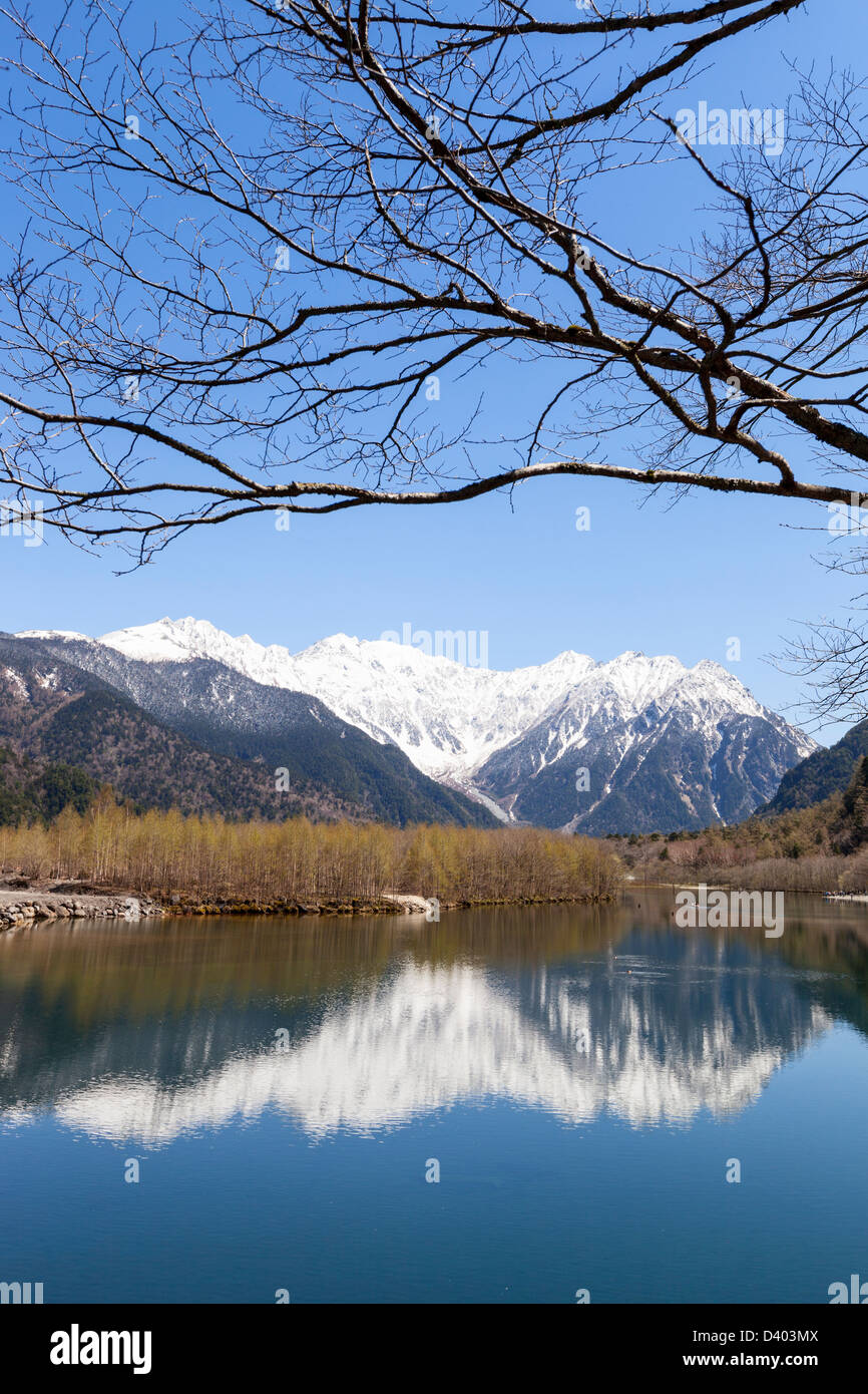 Snow-capped Hotaka mountain range reflected in Taisho Pond in the Kamikochi area of the Japanese Alps. Stock Photo