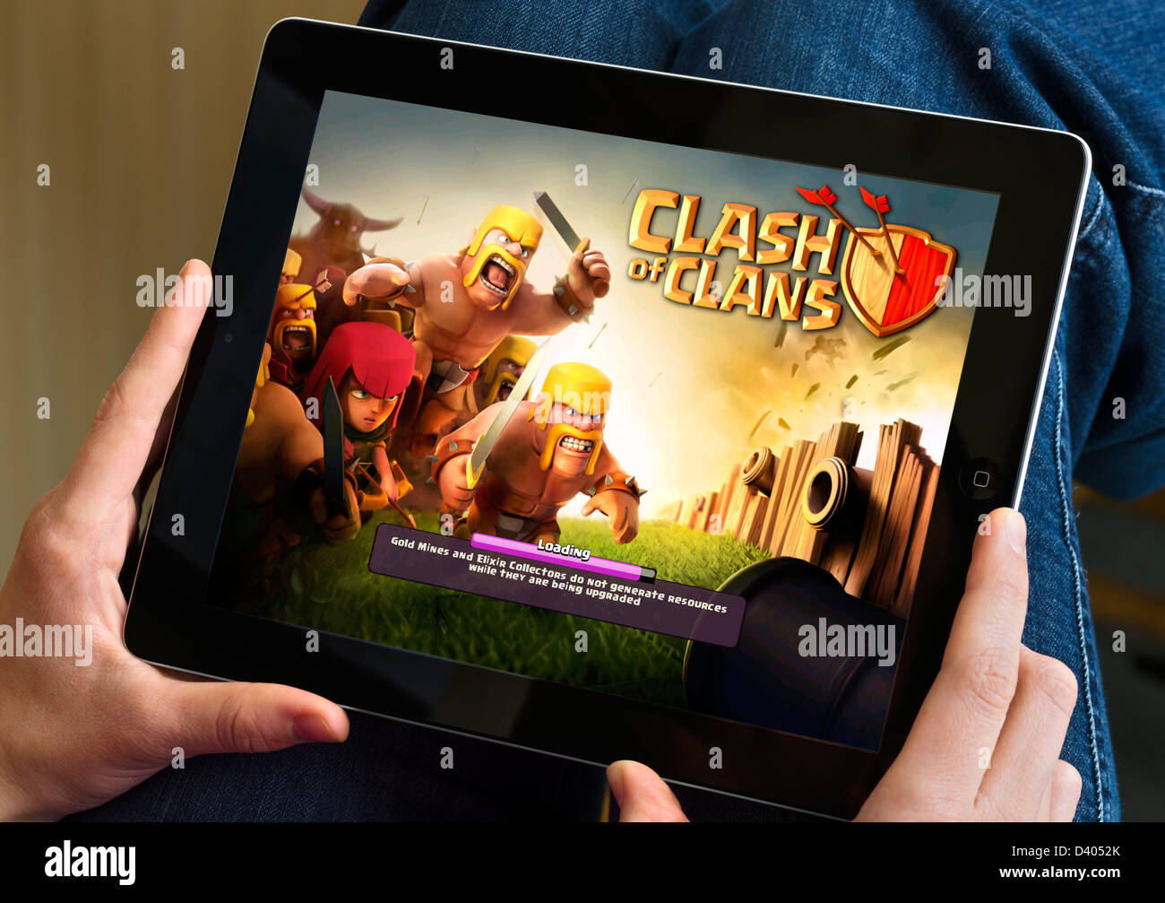 Playing the popular free game Clash of Clans on a 4th generation iPad Stock Photo