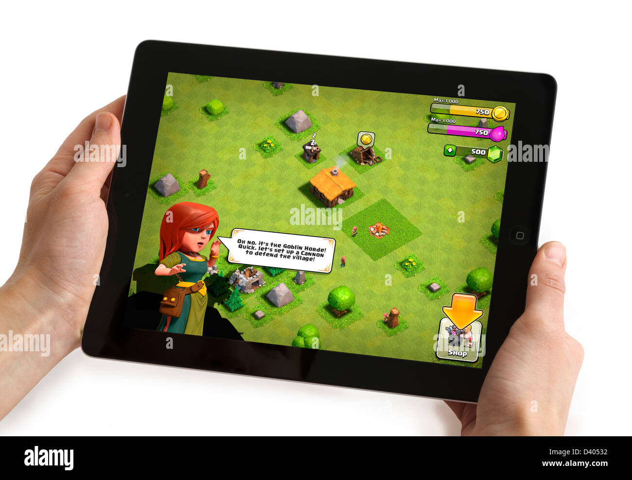 Playing the popular free game Clash of Clans on a 4th generation iPad Stock Photo
