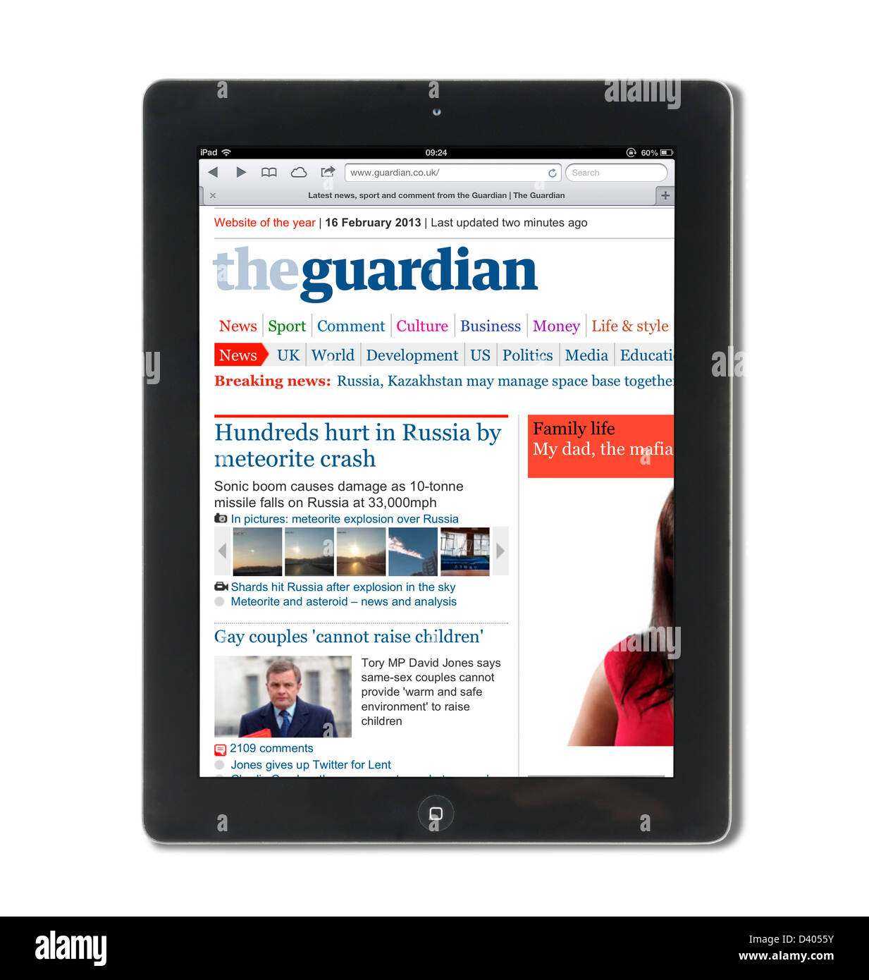 Reading the internet edition of the Guardian online newspaper on a 4th Generation iPad, UK Stock Photo