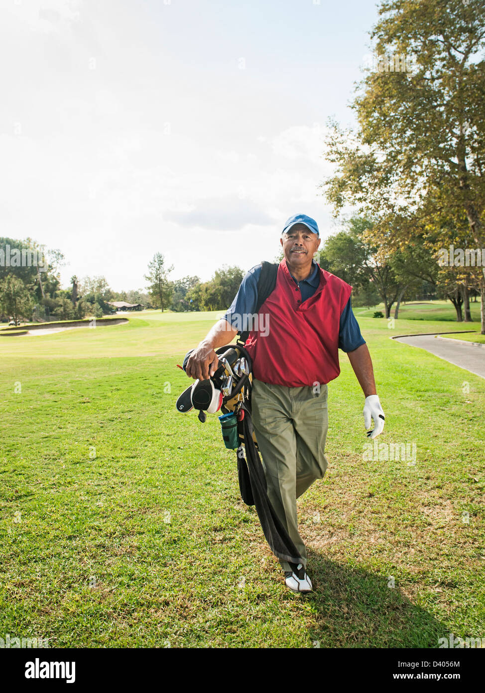 Black man carrying golf clubs Stock Photo Alamy