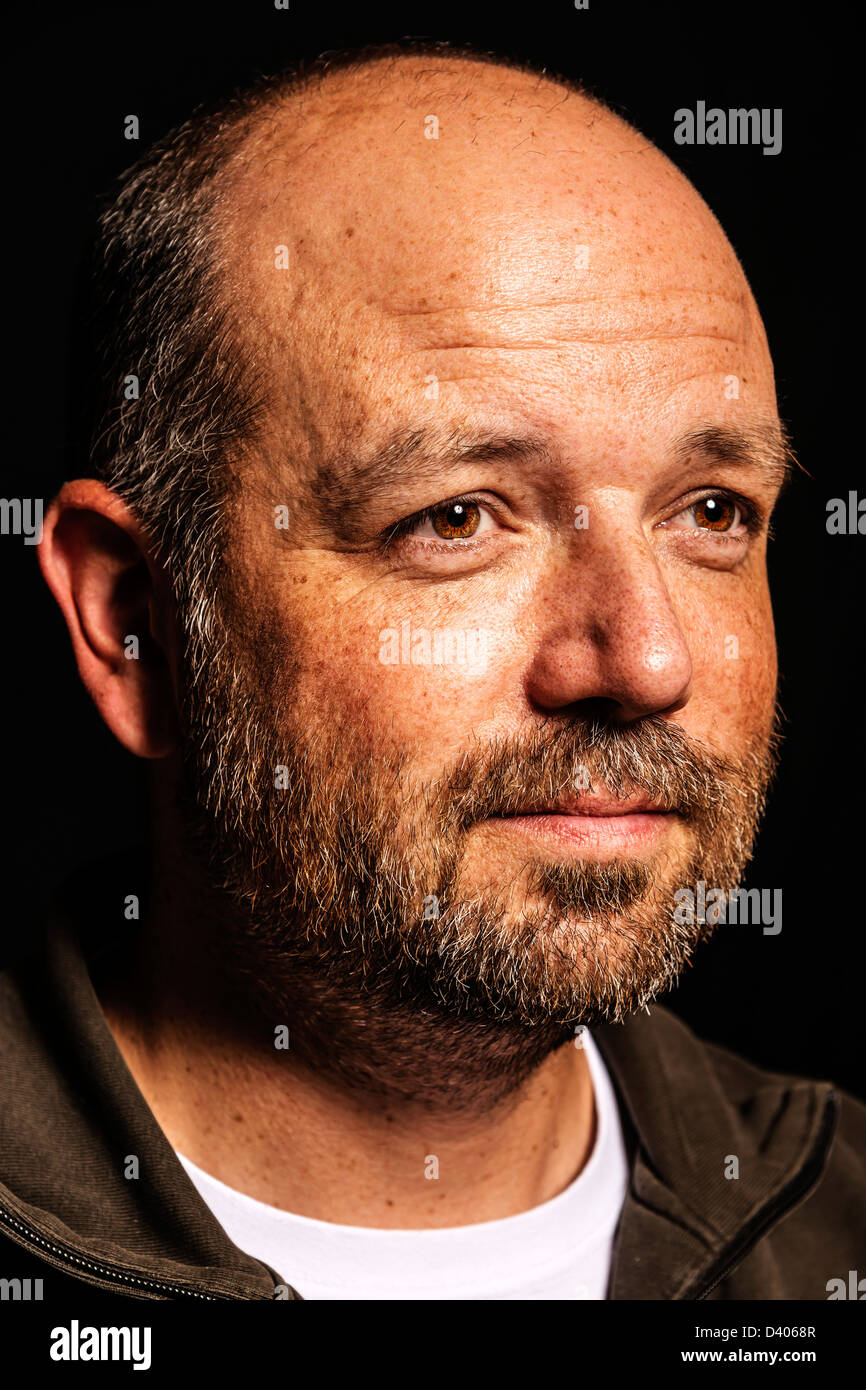 Portrait of a friendly looking, balding and unshaven man Stock Photo