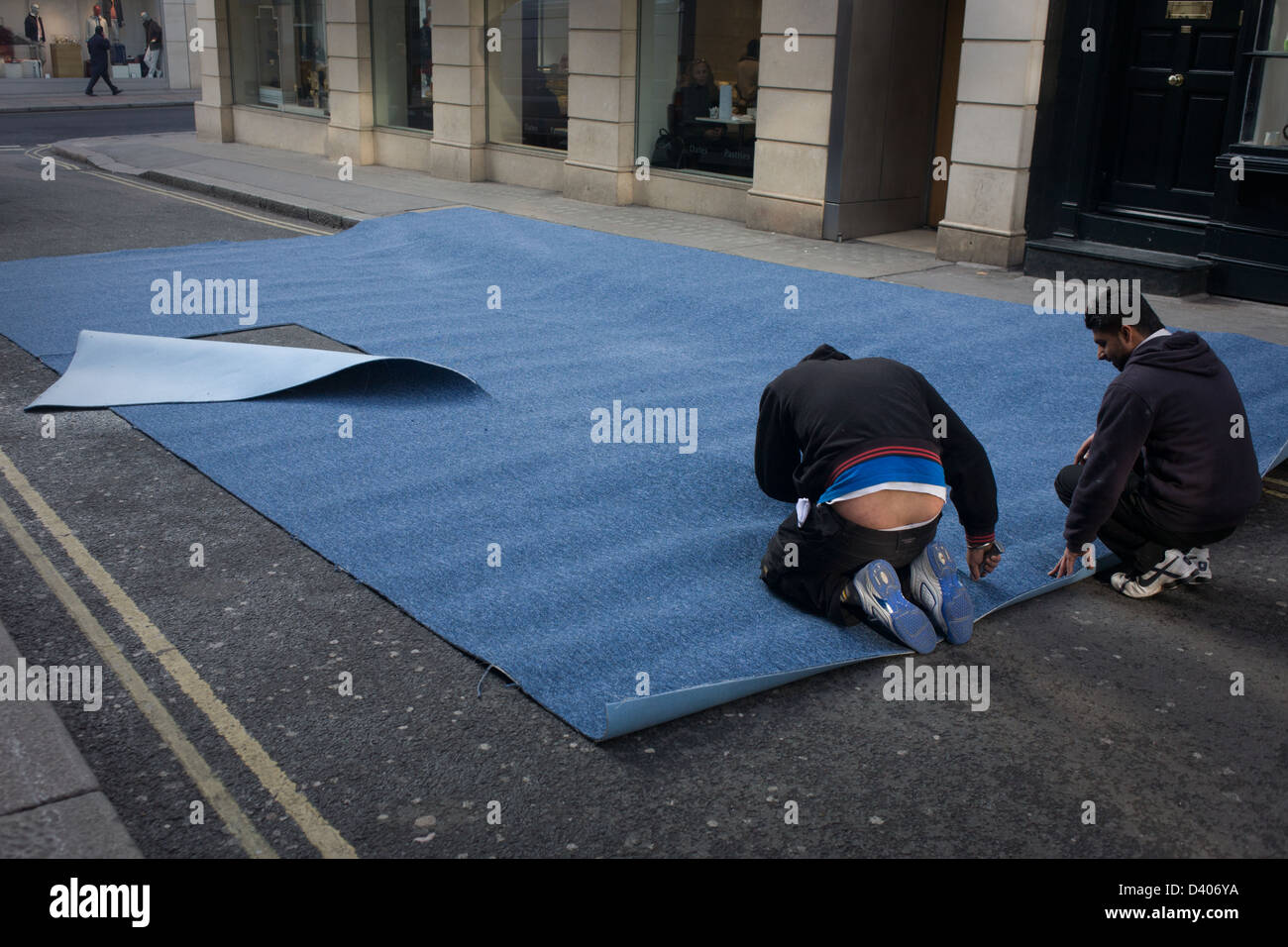 A Team Of Asian Men Measure And Cut Roll Industrial Carpet In Side Street Destined For Nearby Shop Londons New Bond A Team Of Asian Men Measure And Cut Roll Industrial Carpet In Side Street Destined For Nearby Shop Londons New Bond