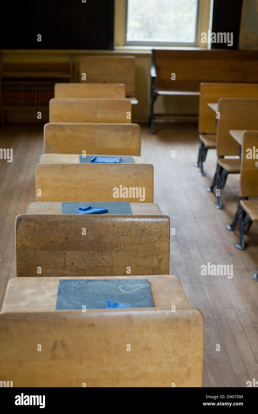 Old classroom with antique chairs and desks with little blackboards on
