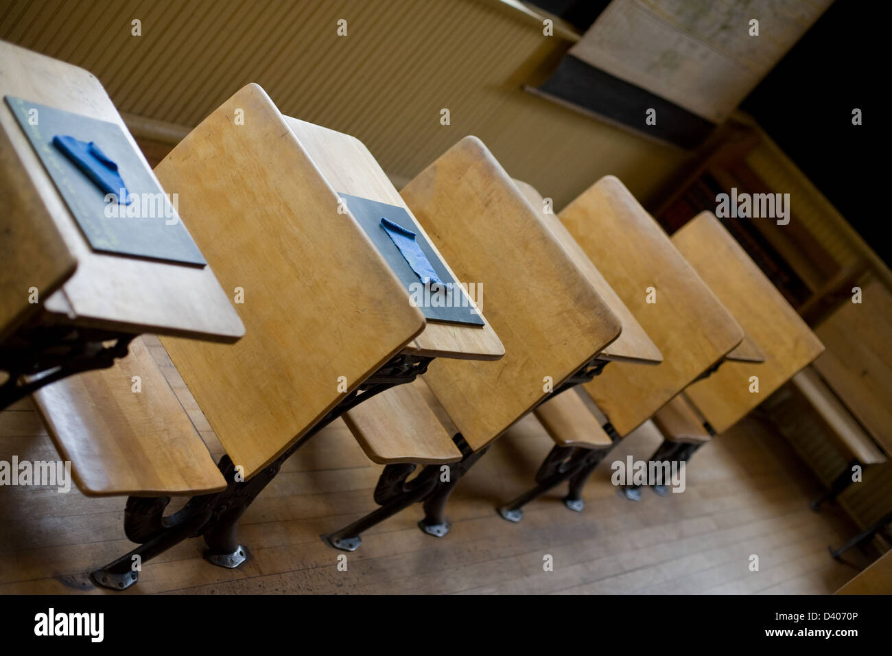 Old classroom with antique chairs and desks with little blackboards on