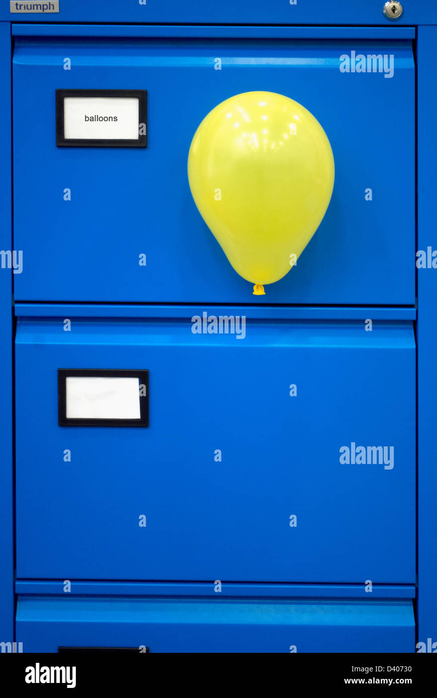 Yellow balloon stuck to blue filing Stock Photo Alamy