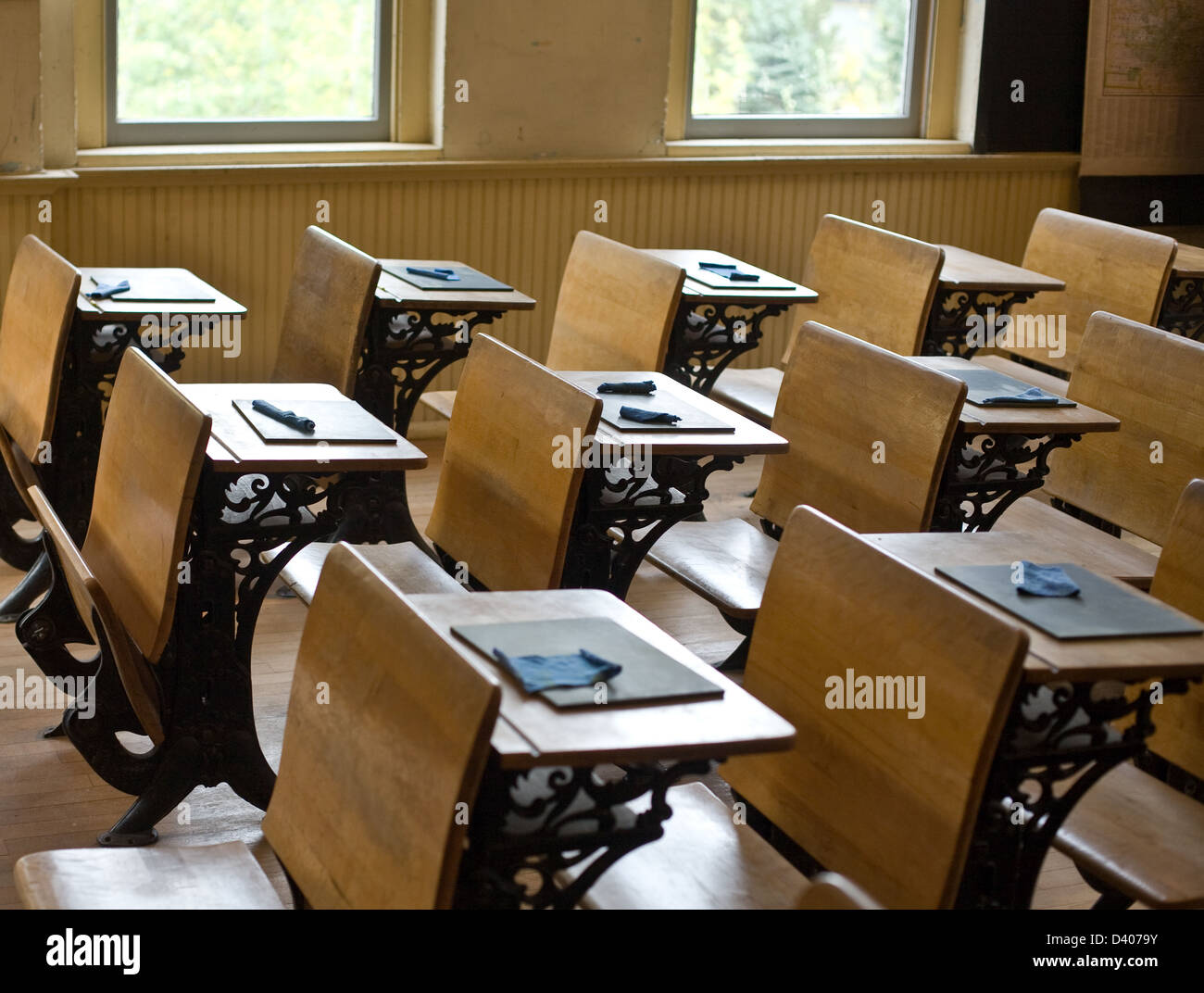 Old classroom with antique chairs and desks with little blackboards on