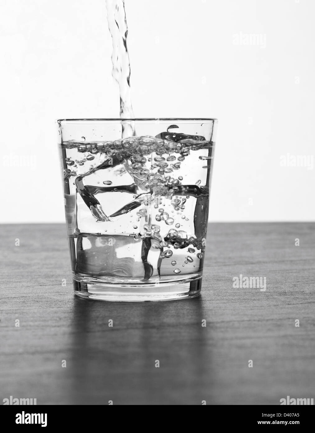 Glass of water over ice cubes with white background Stock Photo - Alamy