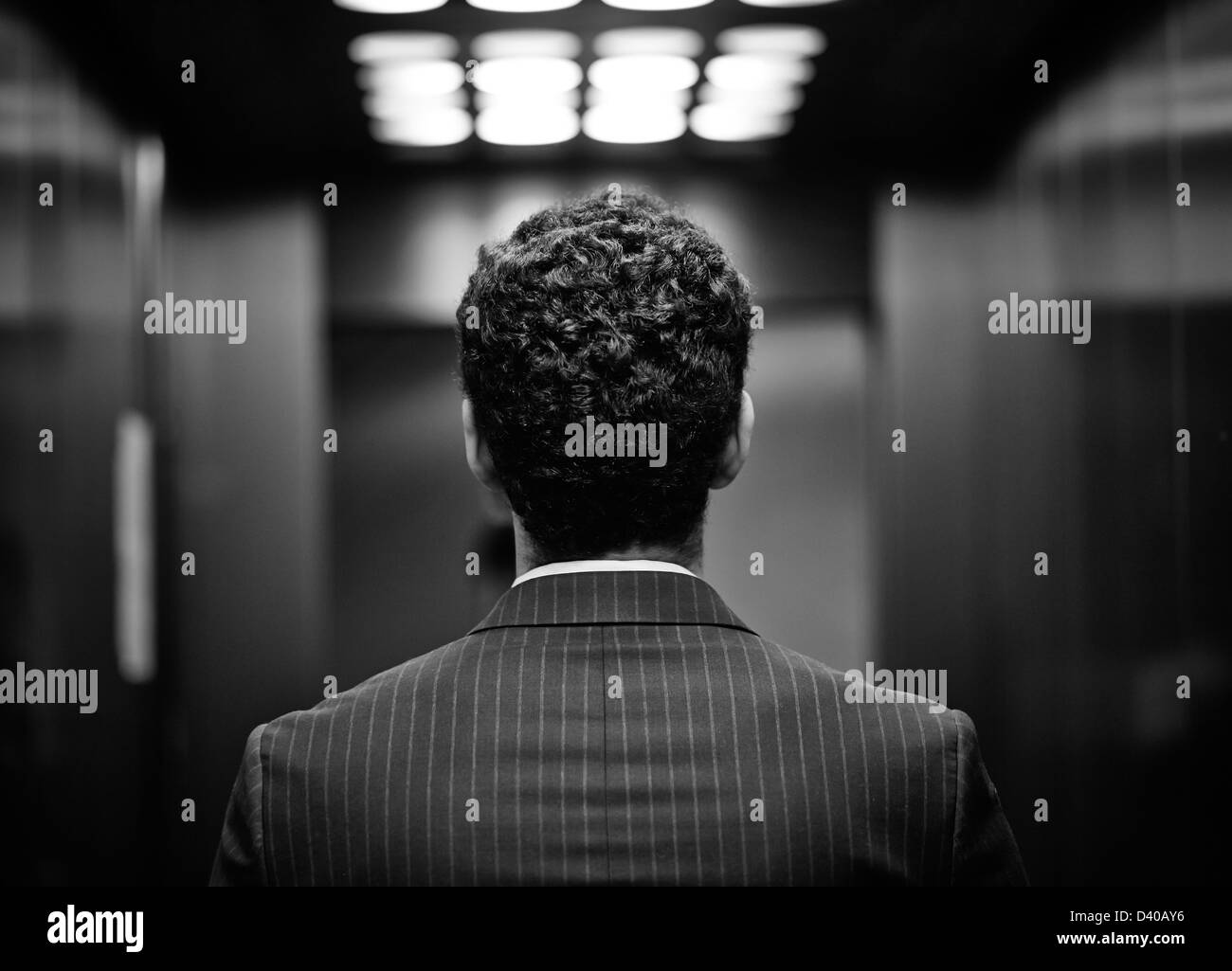 Rear view of young man in suit, black and white image Stock Photo - Alamy