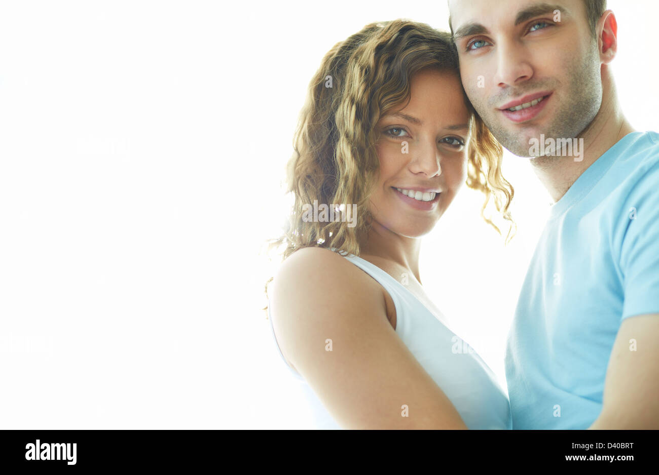 Young happy couple looking at camera Stock Photo - Alamy