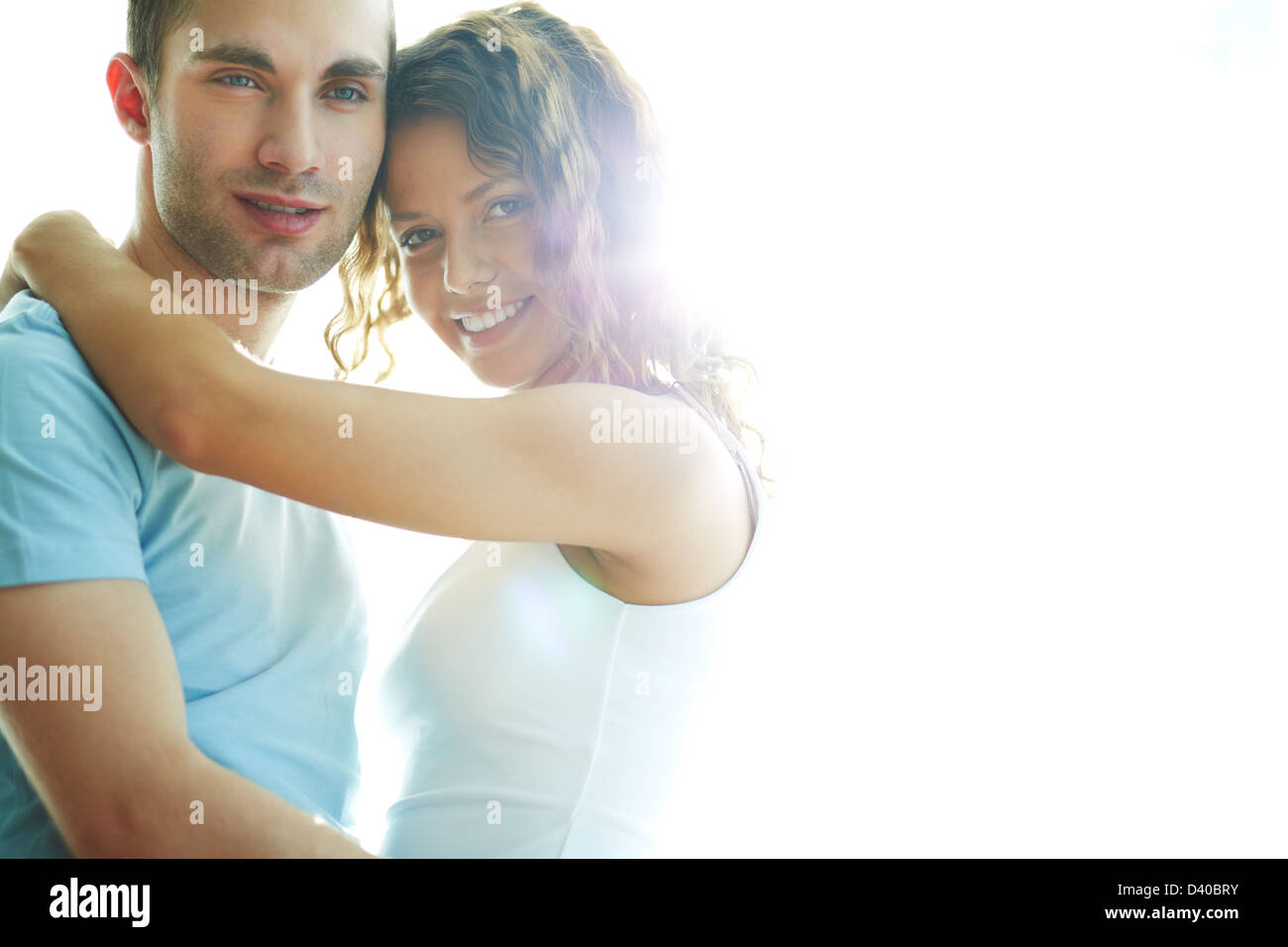 Young happy couple looking at camera Stock Photo - Alamy