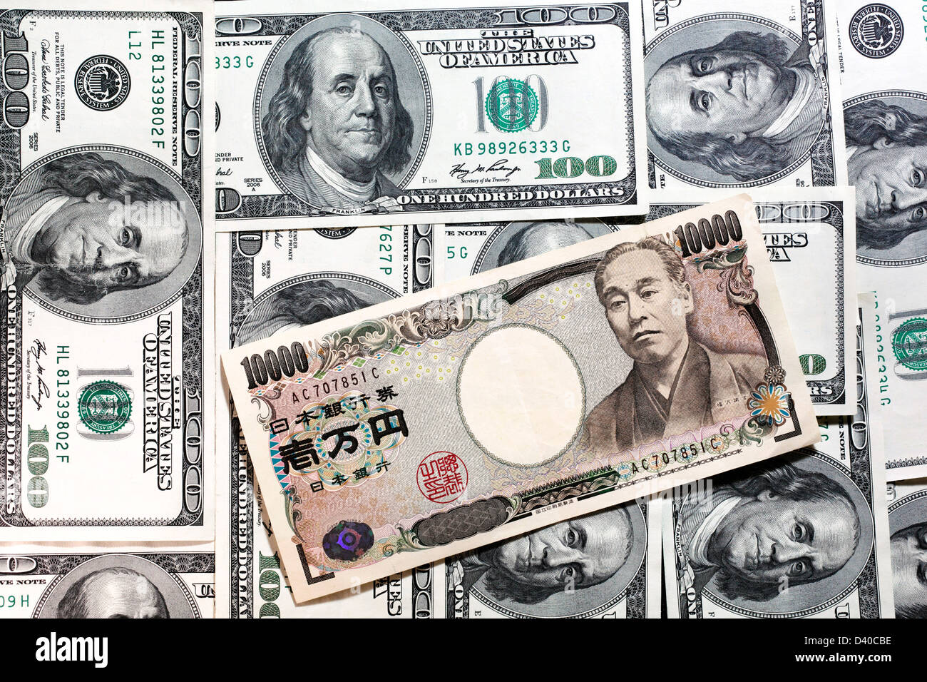 Japanese 10000 Yen banknote with Yukichi Fukuzawa and 100 US Dollars banknotes as background Stock Photo