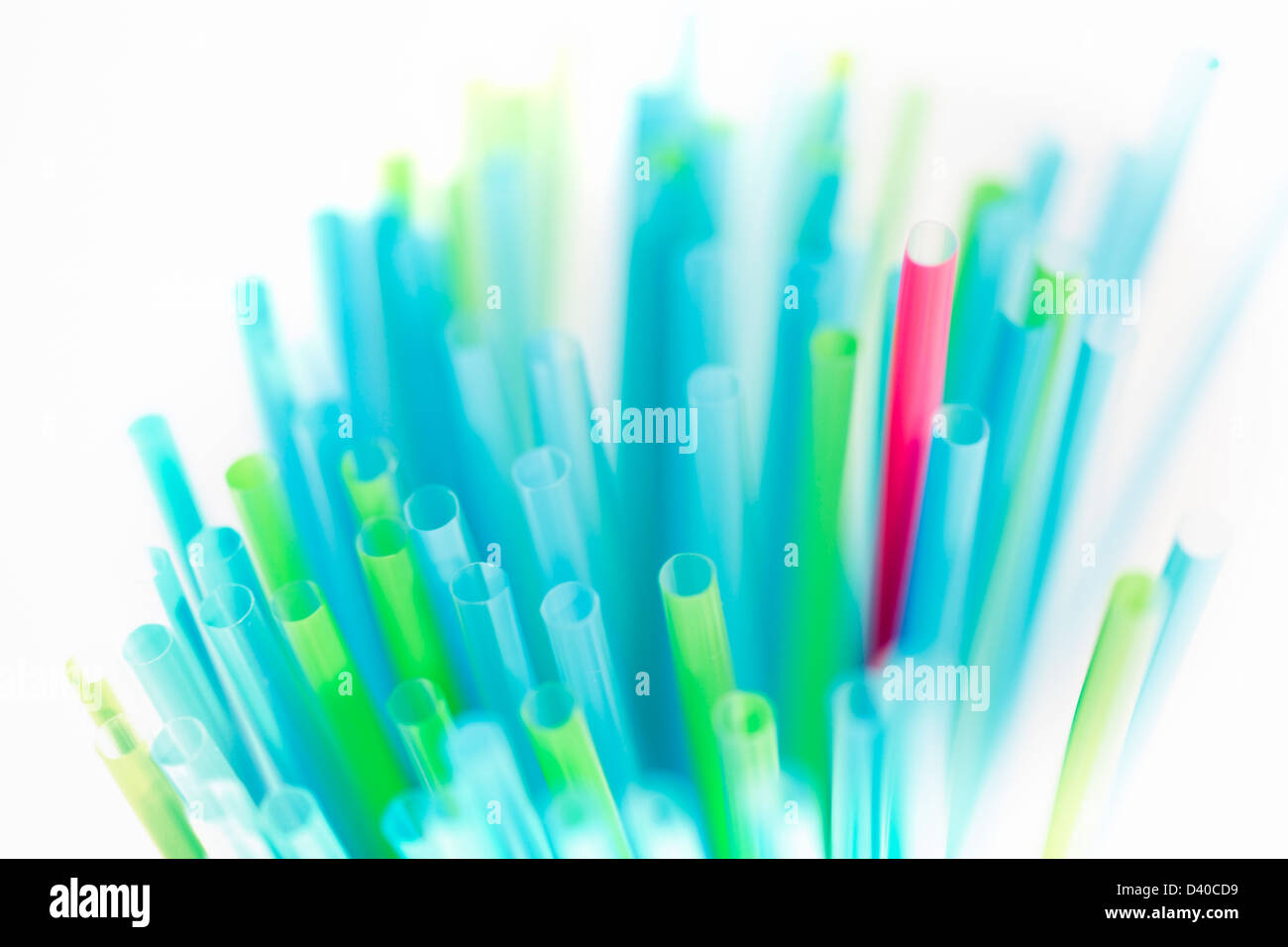 Plastic straws with one standing out Stock Photo