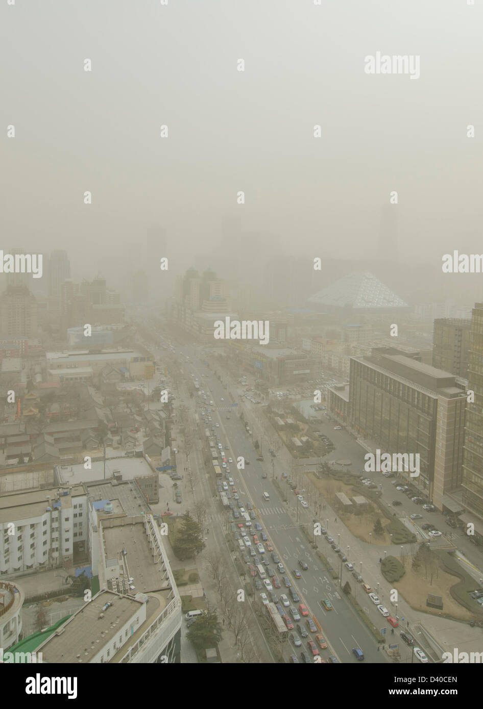 Aerial view across office and residential buildings of the skyline of the Chinese capital city shrouded in smog. Whenever the northerly winds stop, the polluting coal power stations, crop burning and traffic fumes combine, resulting in hazardous air pollution with levels often in excess of 500 on the Air Quality Index, as seen here in the Chaoyang district of Bejiing, China, PRC. © Time-Snaps Stock Photo