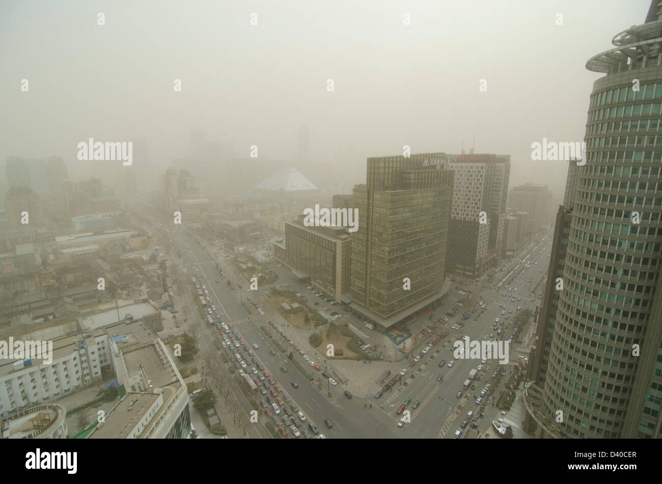 Aerial view across office and residential buildings of the skyline of the Chinese capital city shrouded in smog. Whenever the northerly winds stop, the polluting coal power stations, crop burning and traffic fumes combine, resulting in hazardous air pollution with levels often in excess of 500 on the Air Quality Index, as seen here in the Chaoyang district of Bejiing, China, PRC. © Time-Snaps Stock Photo