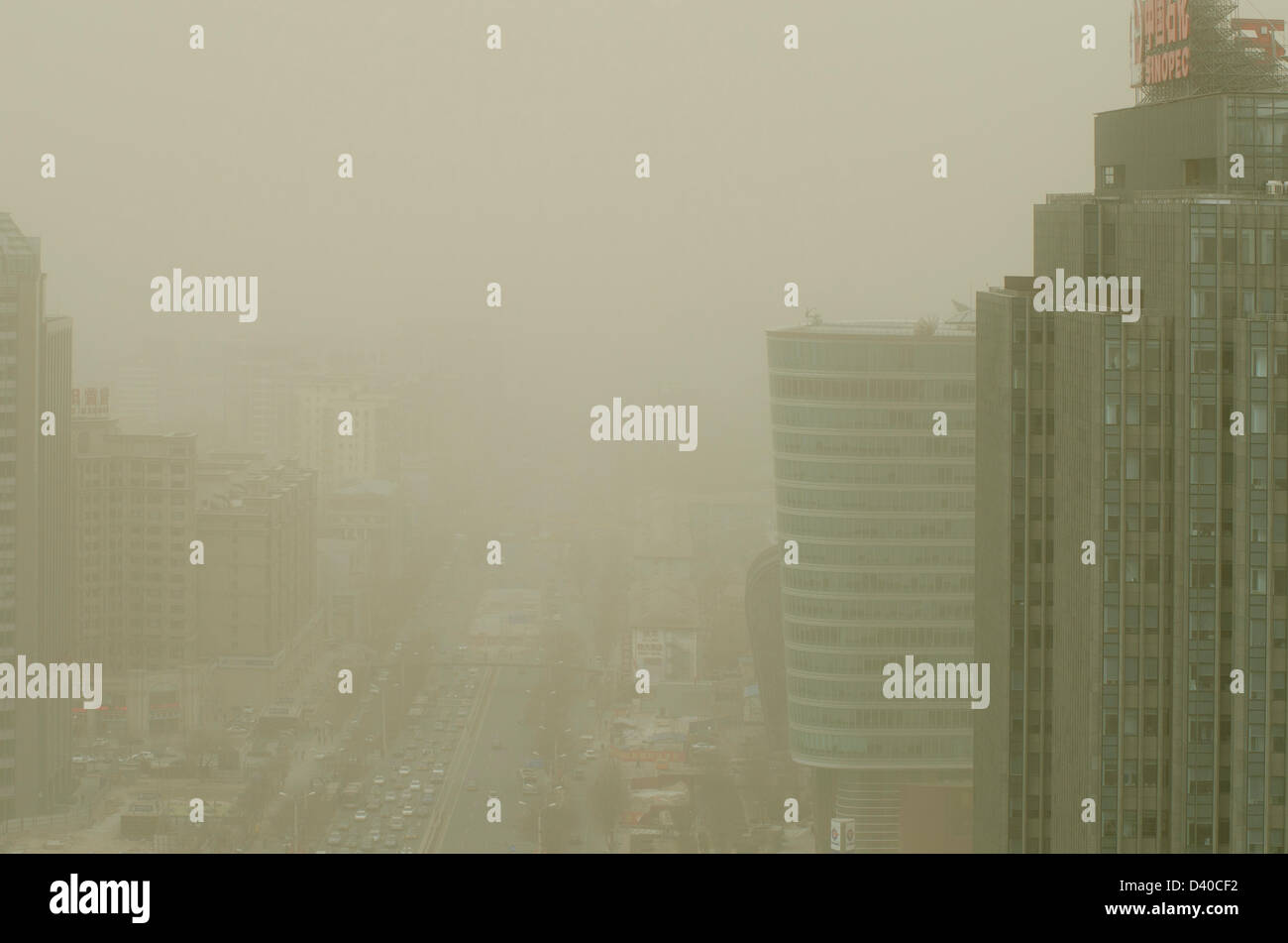Aerial view across office and residential buildings of the skyline of the Chinese capital city shrouded in smog. Whenever the northerly winds stop, the polluting coal power stations, crop burning and traffic fumes combine, resulting in hazardous air pollution with levels often in excess of 500 on the Air Quality Index, as seen here in the Chaoyang district of Bejiing, China, PRC. © Time-Snaps Stock Photo
